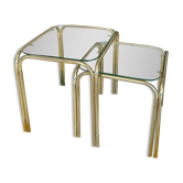 Pair of small nesting coffee tables in gold tubular metal & transparent glass tops