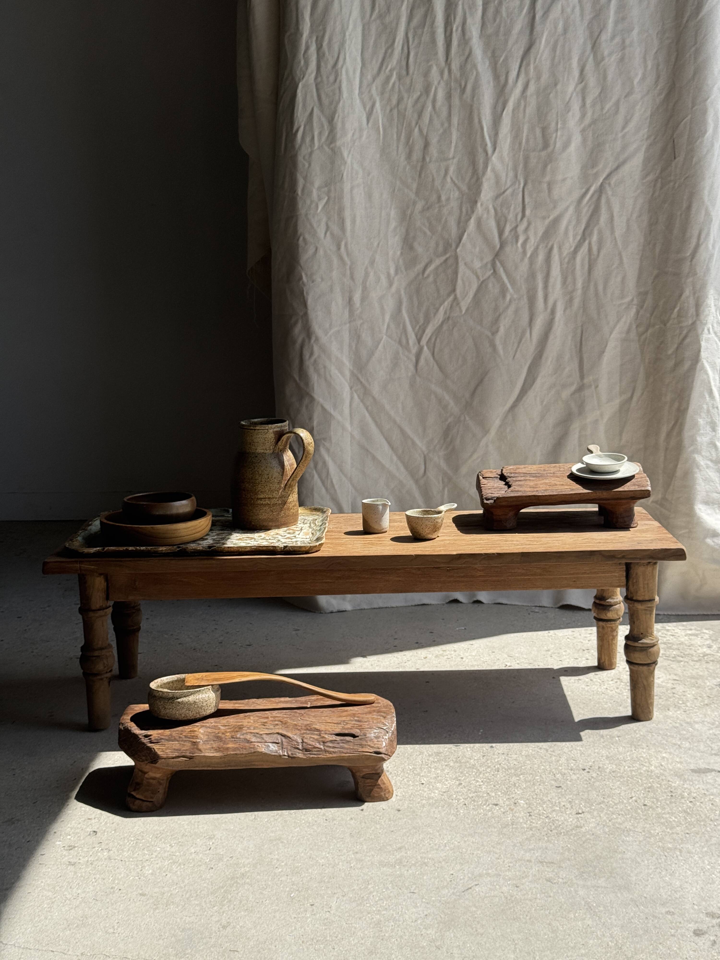 Small stool, footrest in blond teak, organic monoxyle with cut corners.