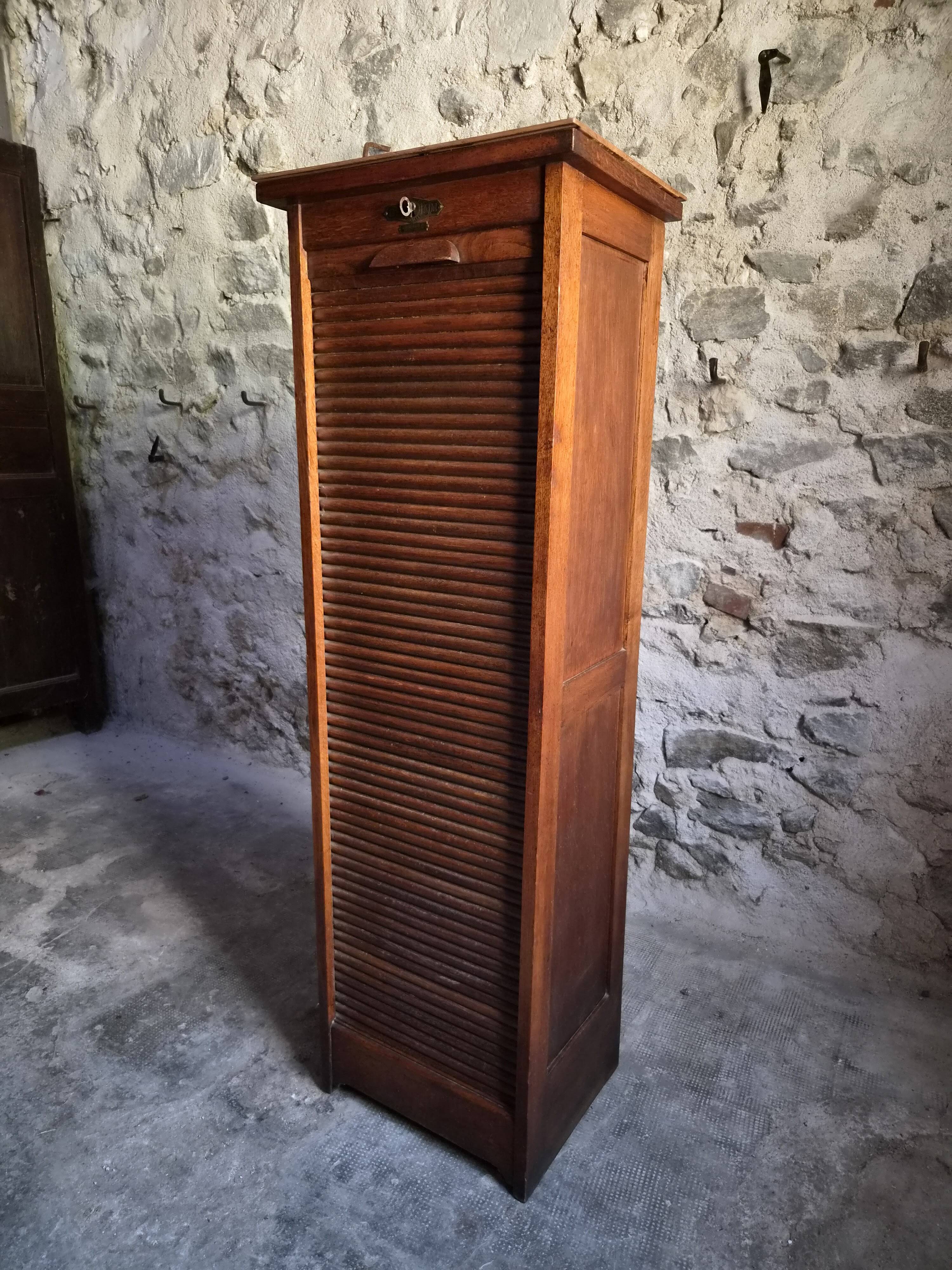 French antique wardrobe with curtain in oak, circa 1920–1930.