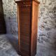 French antique wardrobe with curtain in oak, circa 1920–1930.