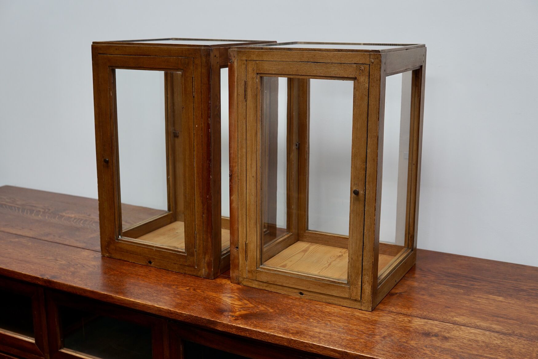 pair of faux oak shop display cabinets, circa 1920s