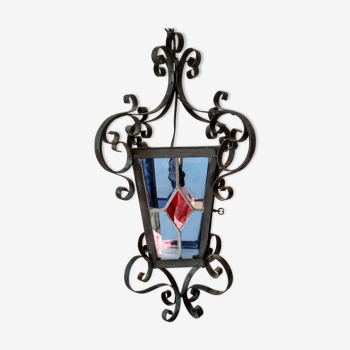 Wrought-iron lantern and polychrome stained glass windows