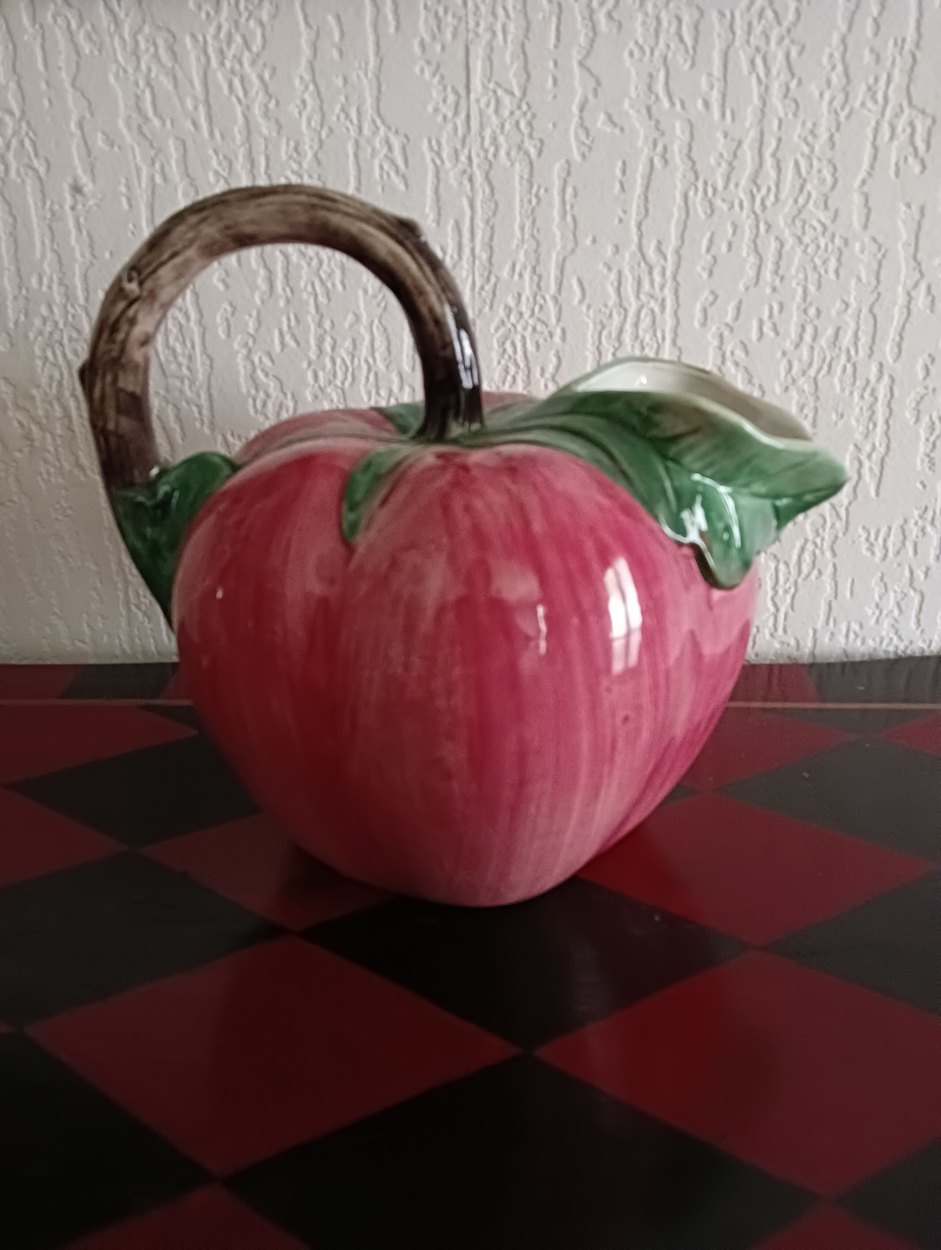 Pink pitcher in the shape of a strawberry, Italian slurry.