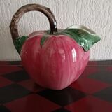 Pink pitcher in the shape of a strawberry, Italian slurry.