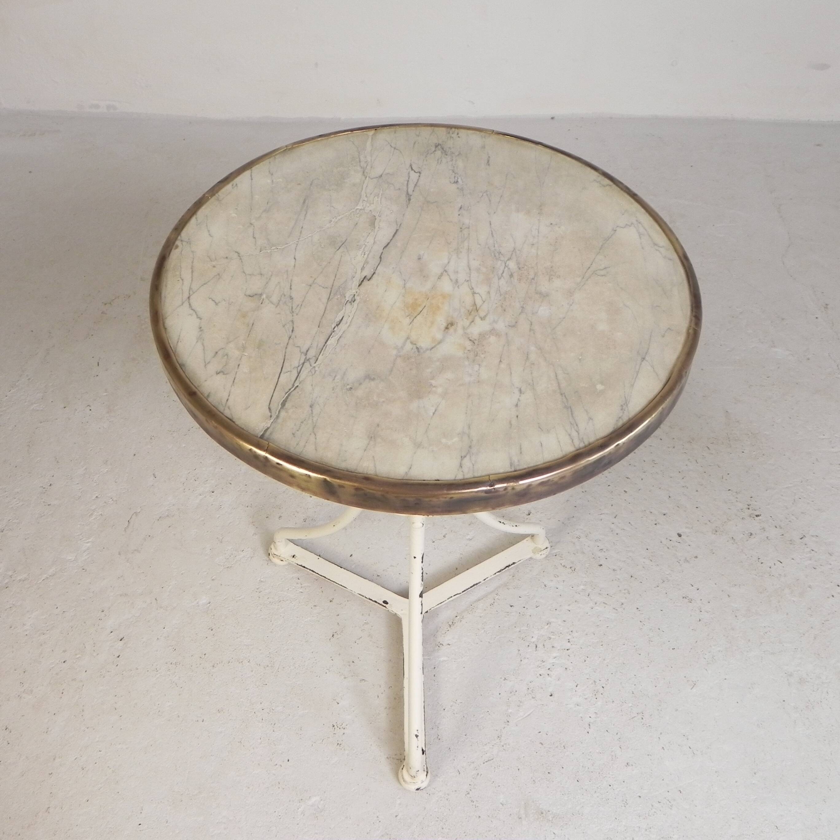 Bistro table with a marble top and brass edging, early 20th century.