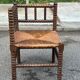 Brutalist corner chair in turned wood with straw bobbins, 1960.