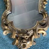 Antique scalloped mirror with pediment decorated with cherubs – carved gilded wood