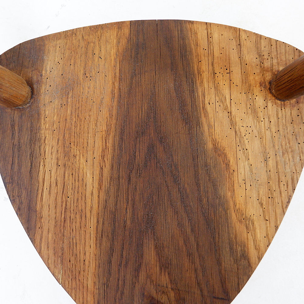 Rustic tripod stool with a triangular seat, 1960s.