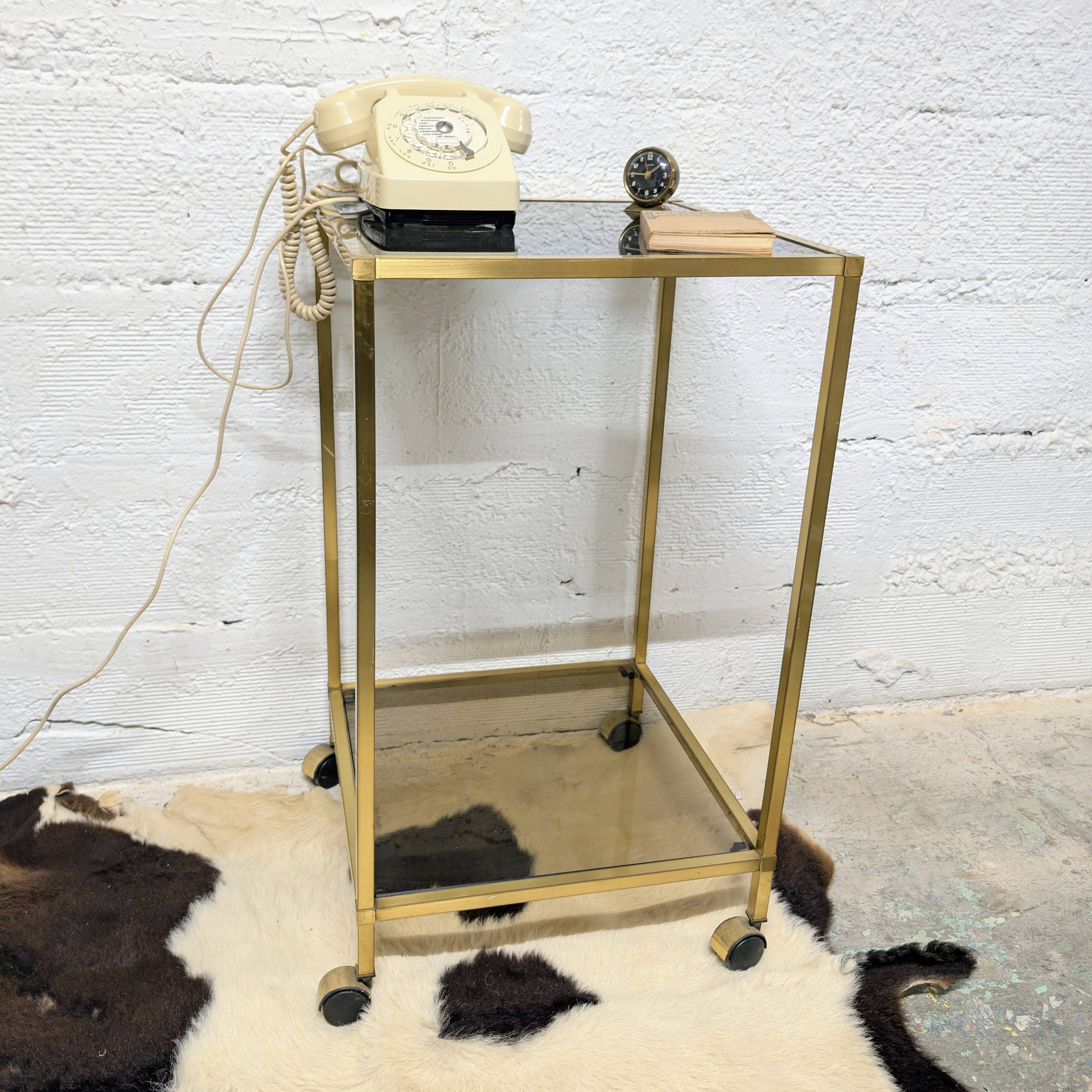 Vintage rolling table in brass and smoked glass