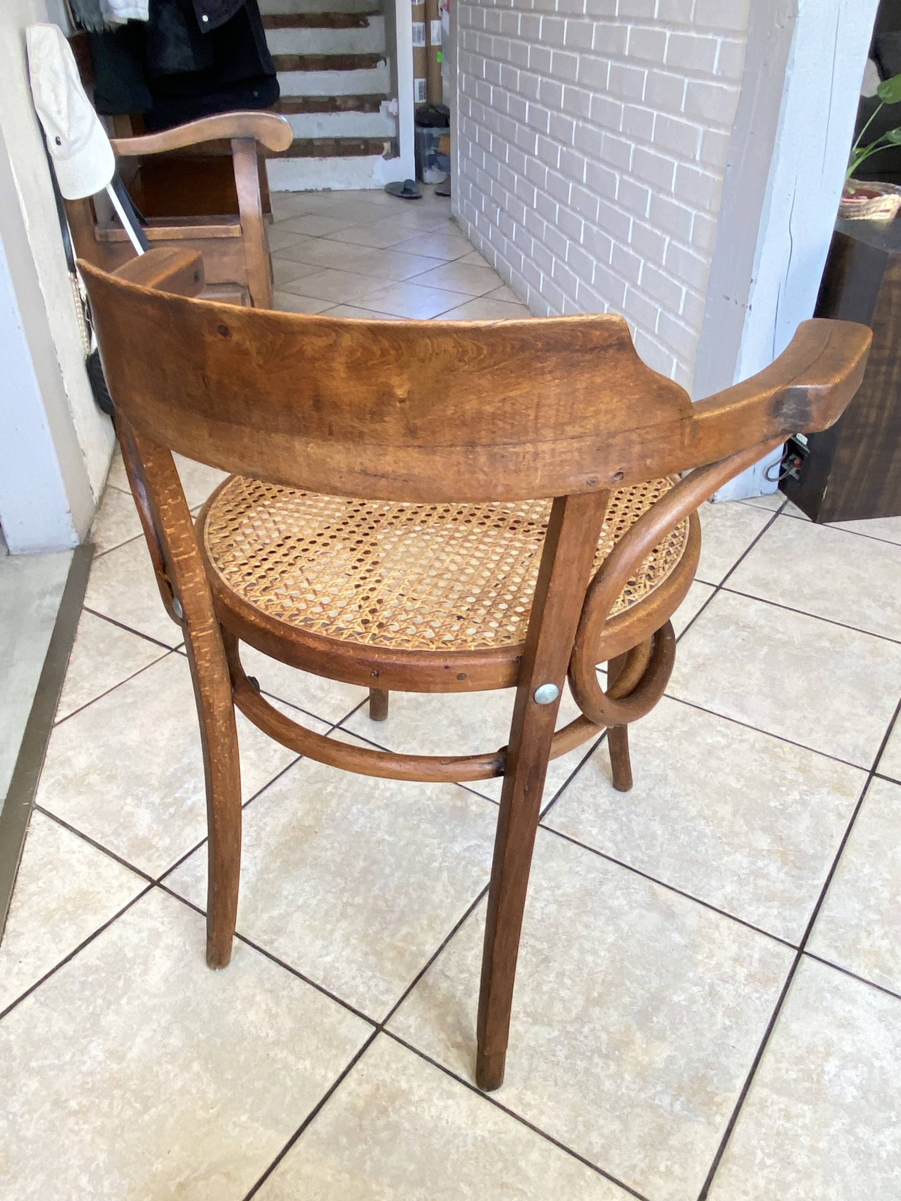 Bistro chair with a curved wooden frame and caned seat from the 1930s.