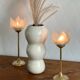 Pair of tulip-shaped candle holders in frosted glass and brass.