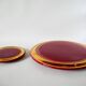 set of trivets, bottle coasters and knife holders in art de cherry-colored ceramic
