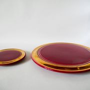 set of trivets, bottle coasters and knife holders in art de cherry-colored ceramic