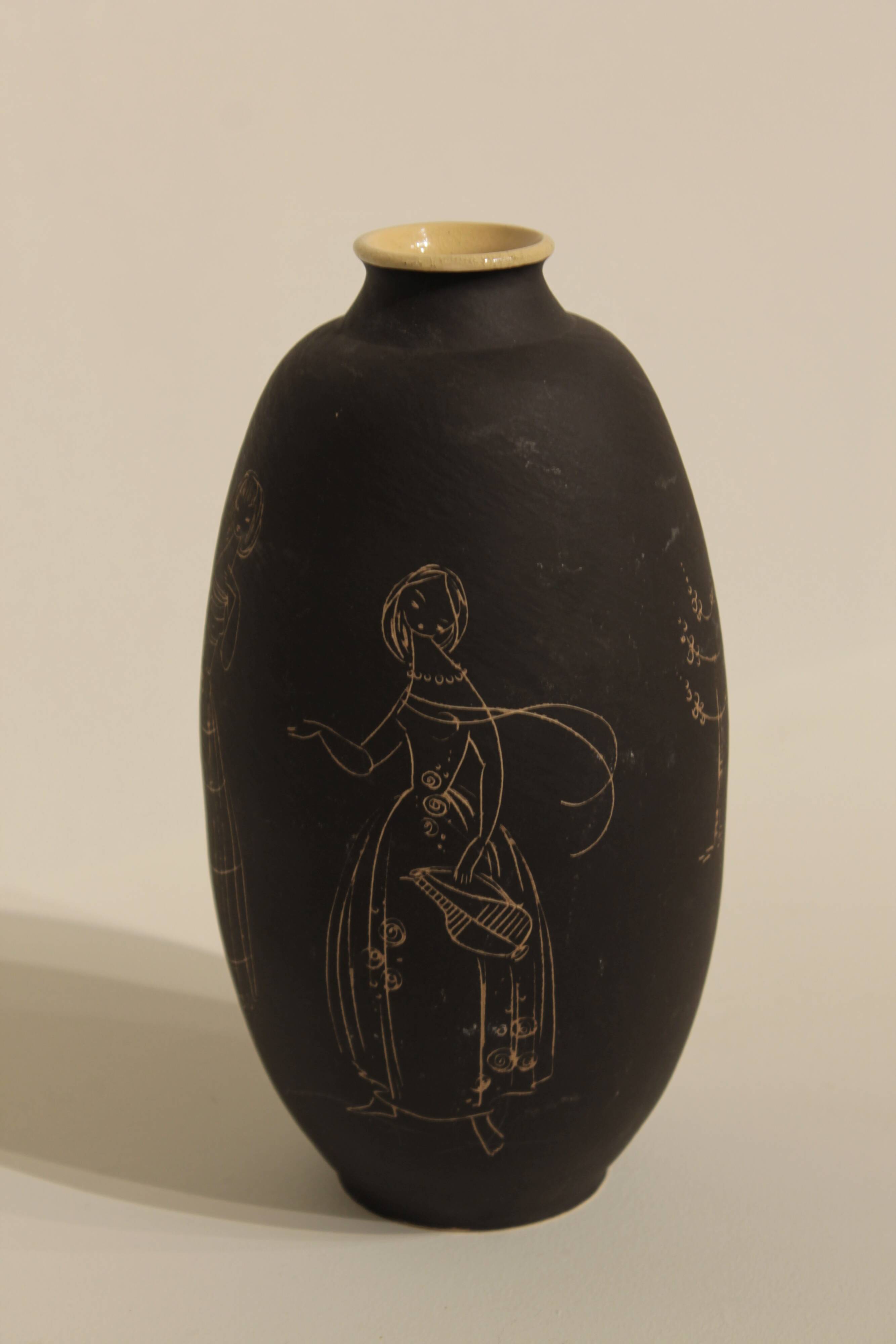 Ceramic vase decorated with women and a tree.