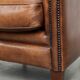 Sheepskin club armchair with a cognac colour finished with decorative nails