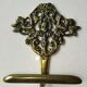 Decorative coat hook with cherubs/putti in aged brass.