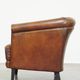 Neat, elegantly finished, cozy sheepskin club armchair with a fixed seat cushion