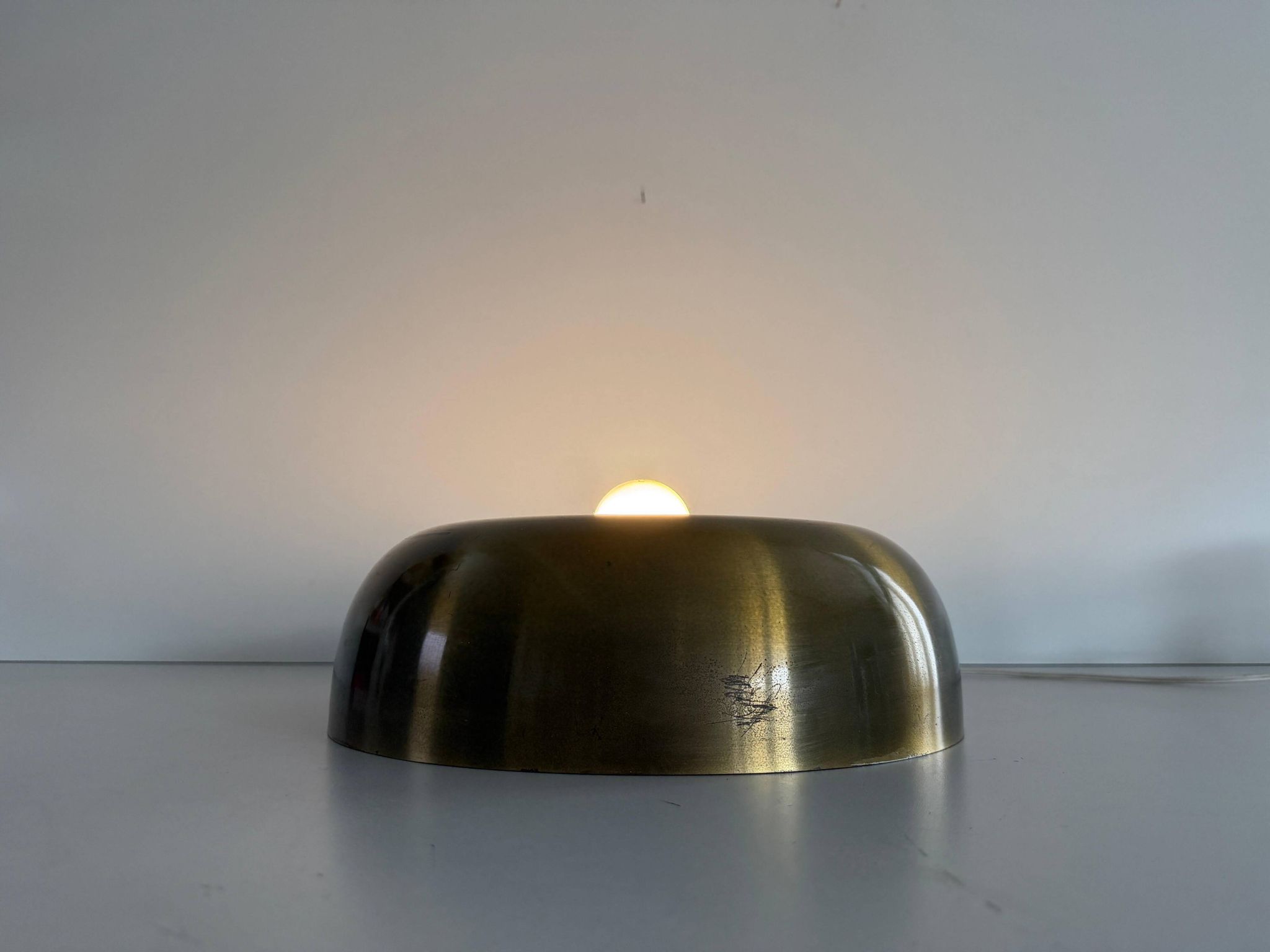 Flush-mounted disc-shaped brass fixture from the mid-century, 1960, Italy.