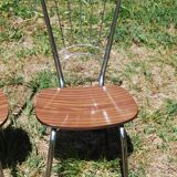 Pair of formica chairs with chrome metal backs in the shape of a lyre.