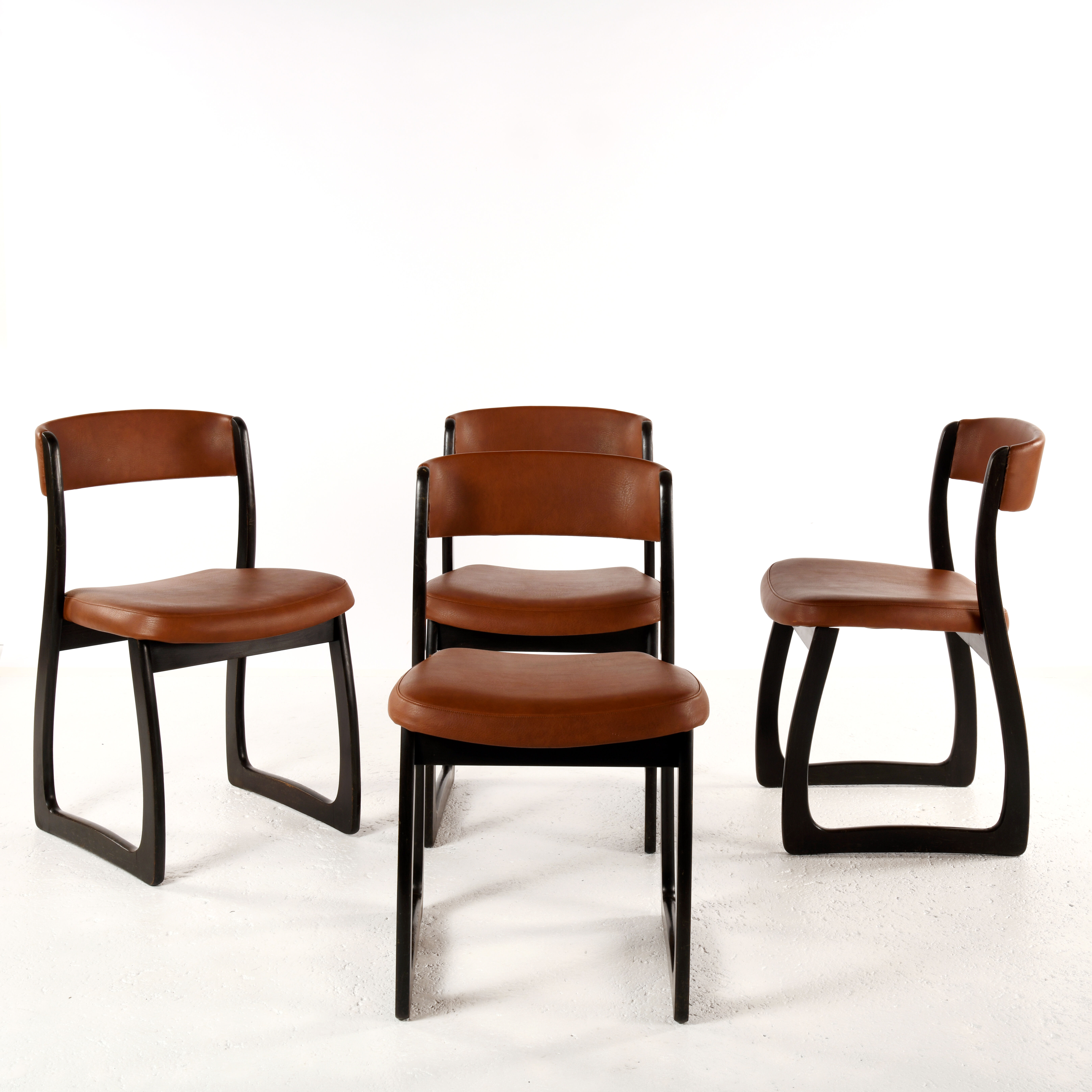 Set of 4 vintage wood and skai sled chairs