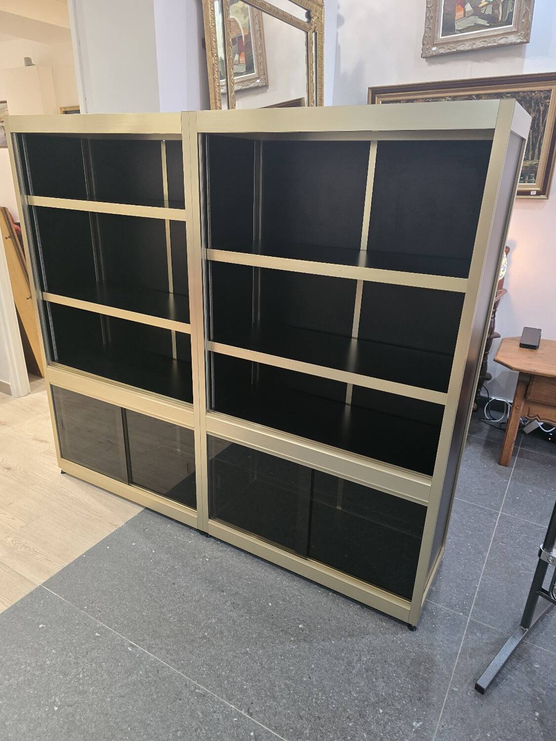 1970s design library with gold metal and lacquered wood.