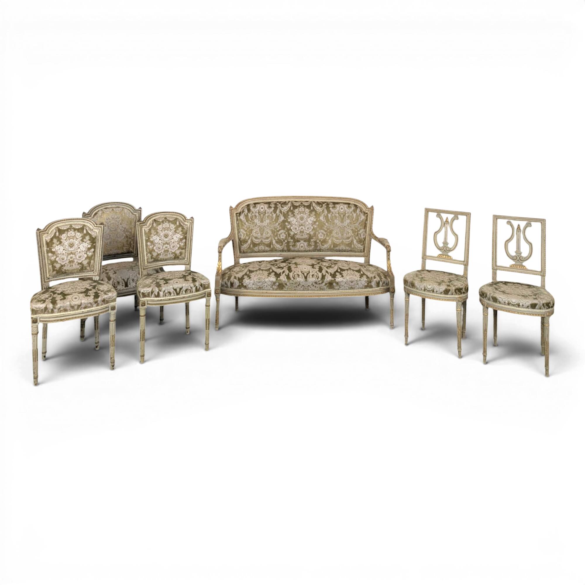 Cream lacquered Louis XVI style cabriolet salon with gold highlights.