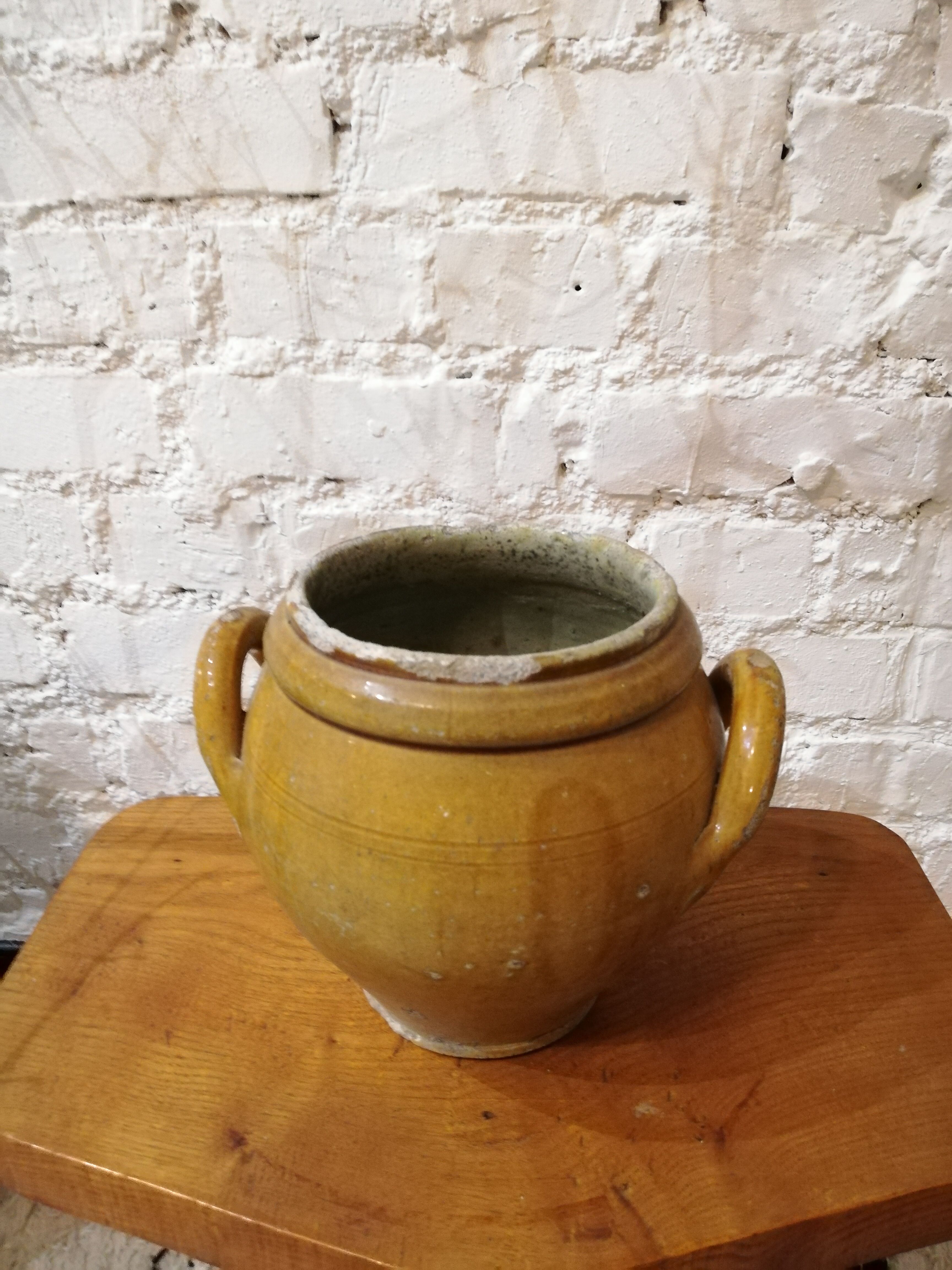 Old yellow glazed terracotta pot