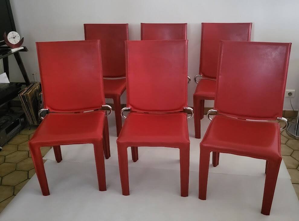 Red leather dining chairs by Arper