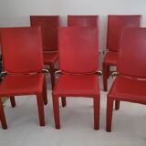 Red leather dining chairs by Arper