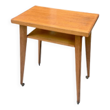 Varnished wooden trolley on wheels