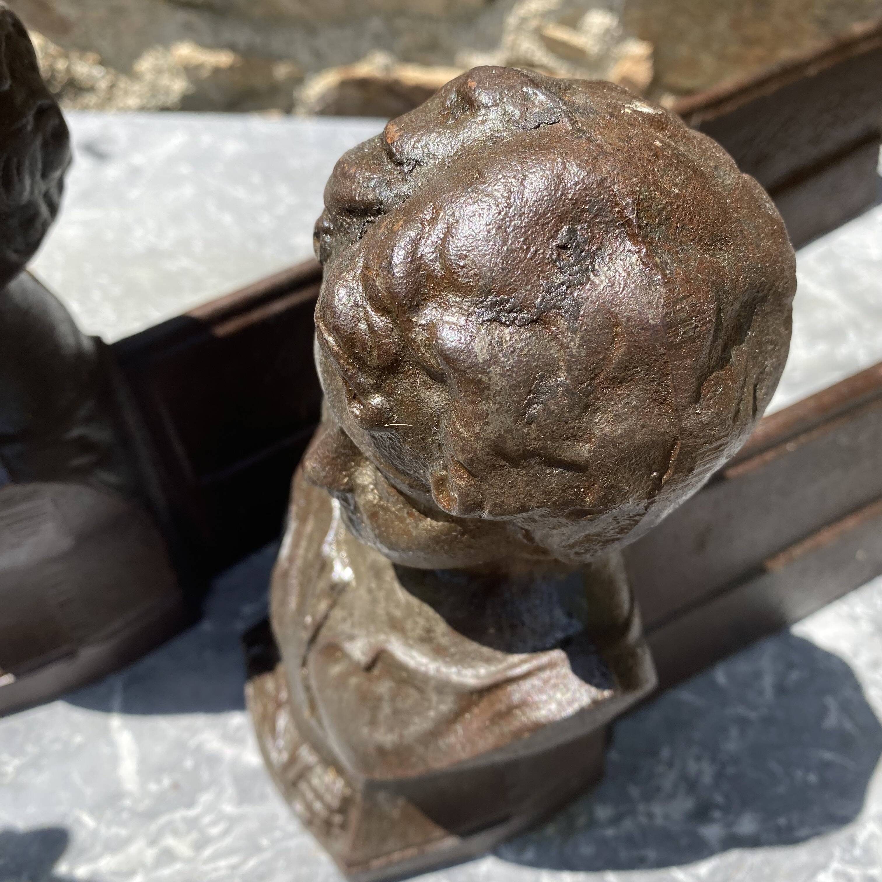 Pair of antique cast iron fire dogs "The Conquering Love"