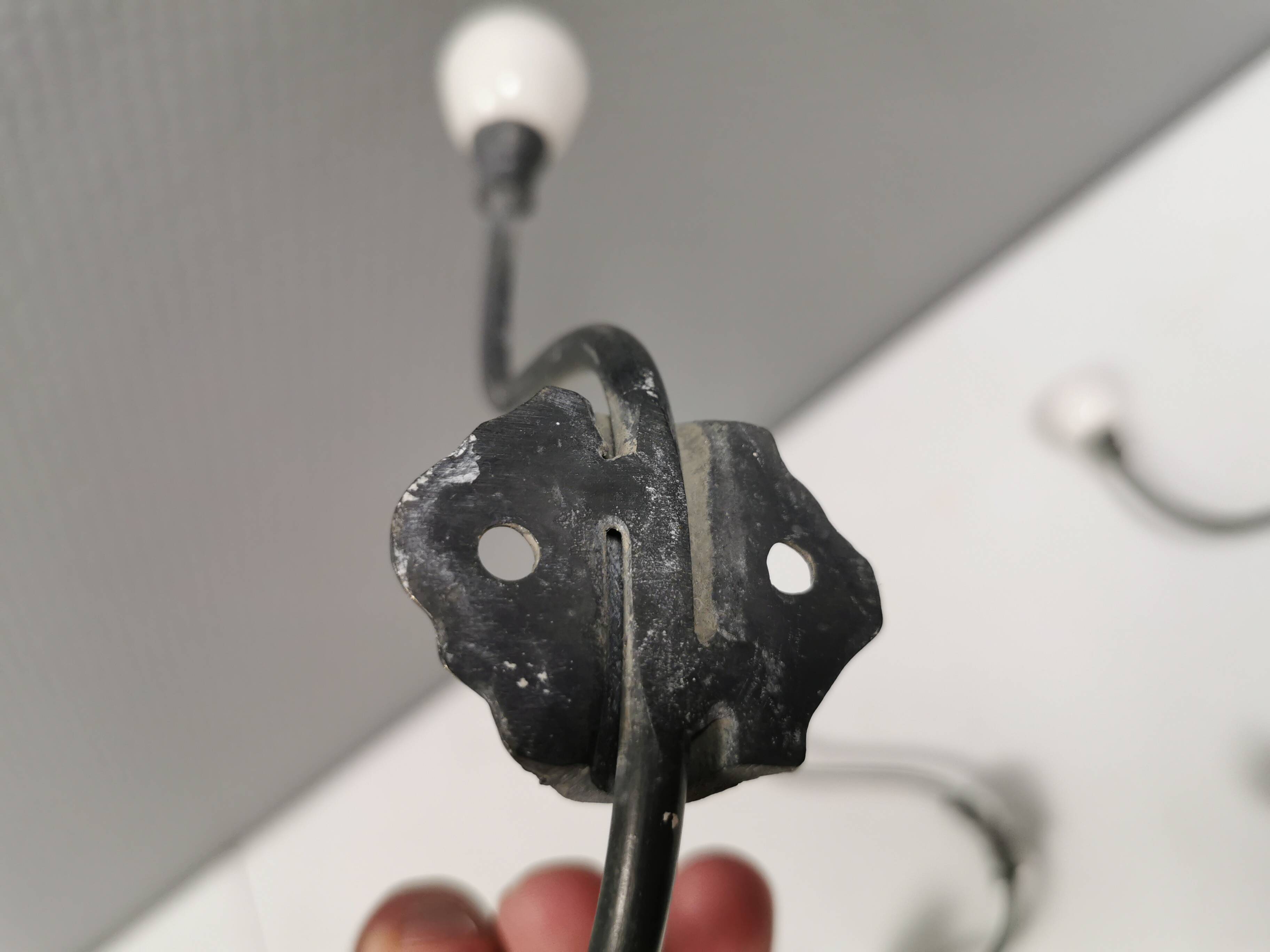 Coat hooks made of galvanized brass and raw white porcelain