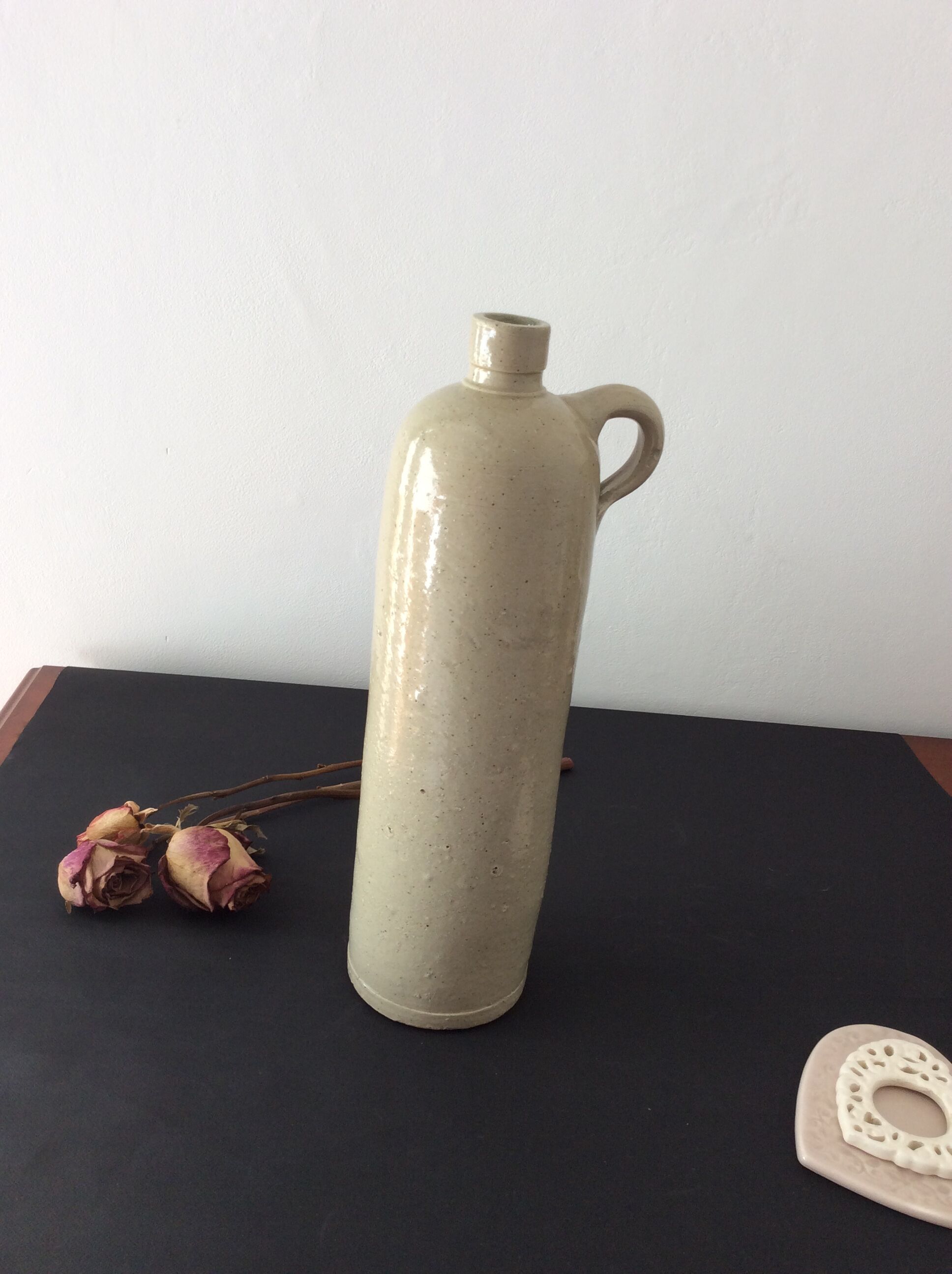 Old stoneware bottle with ear, loop