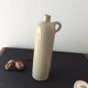 Old stoneware bottle with ear, loop