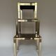 Set of three nesting side tables in brass and smoked mirror.