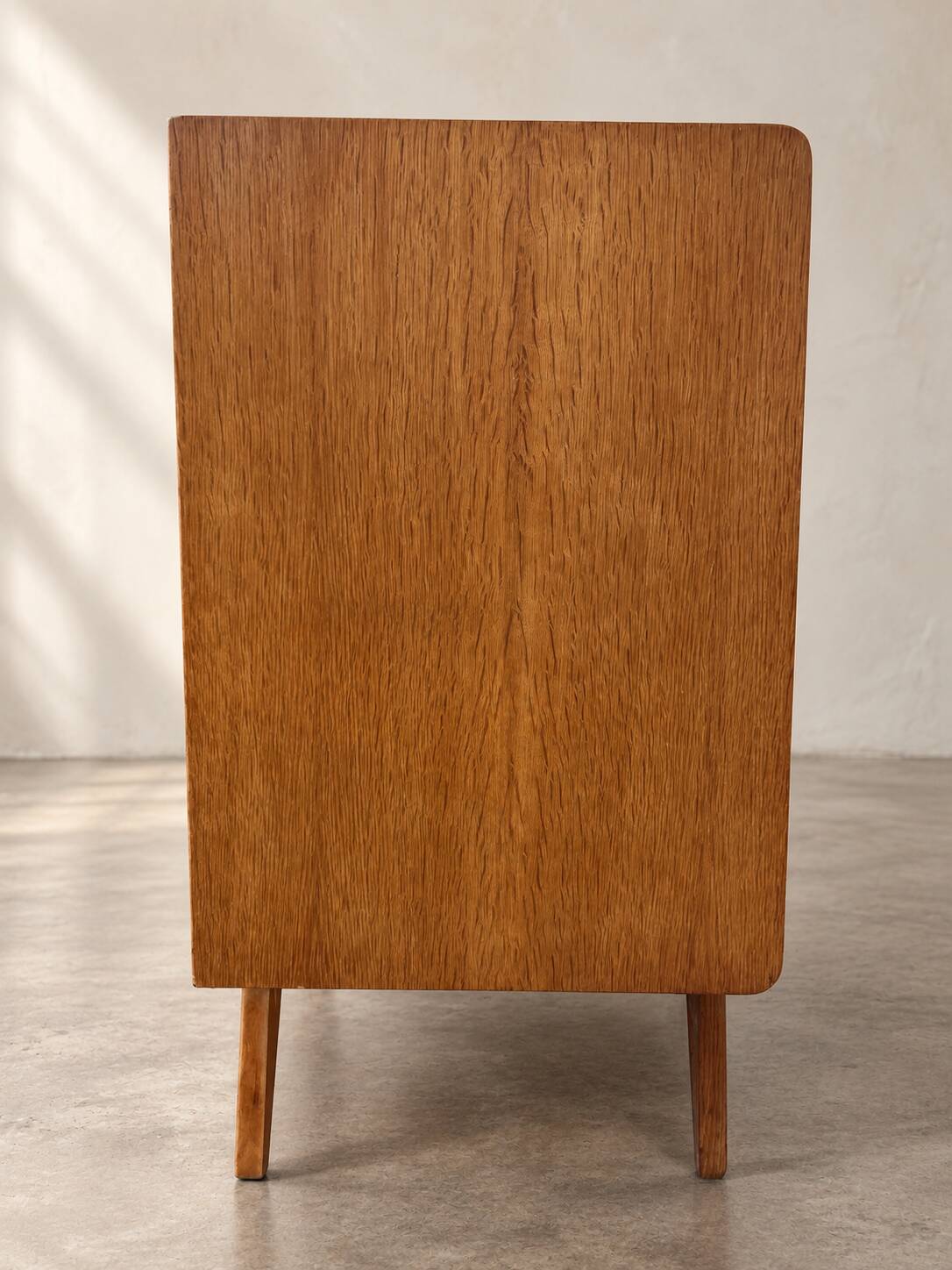 Vintage 1960s commode with tapered legs.