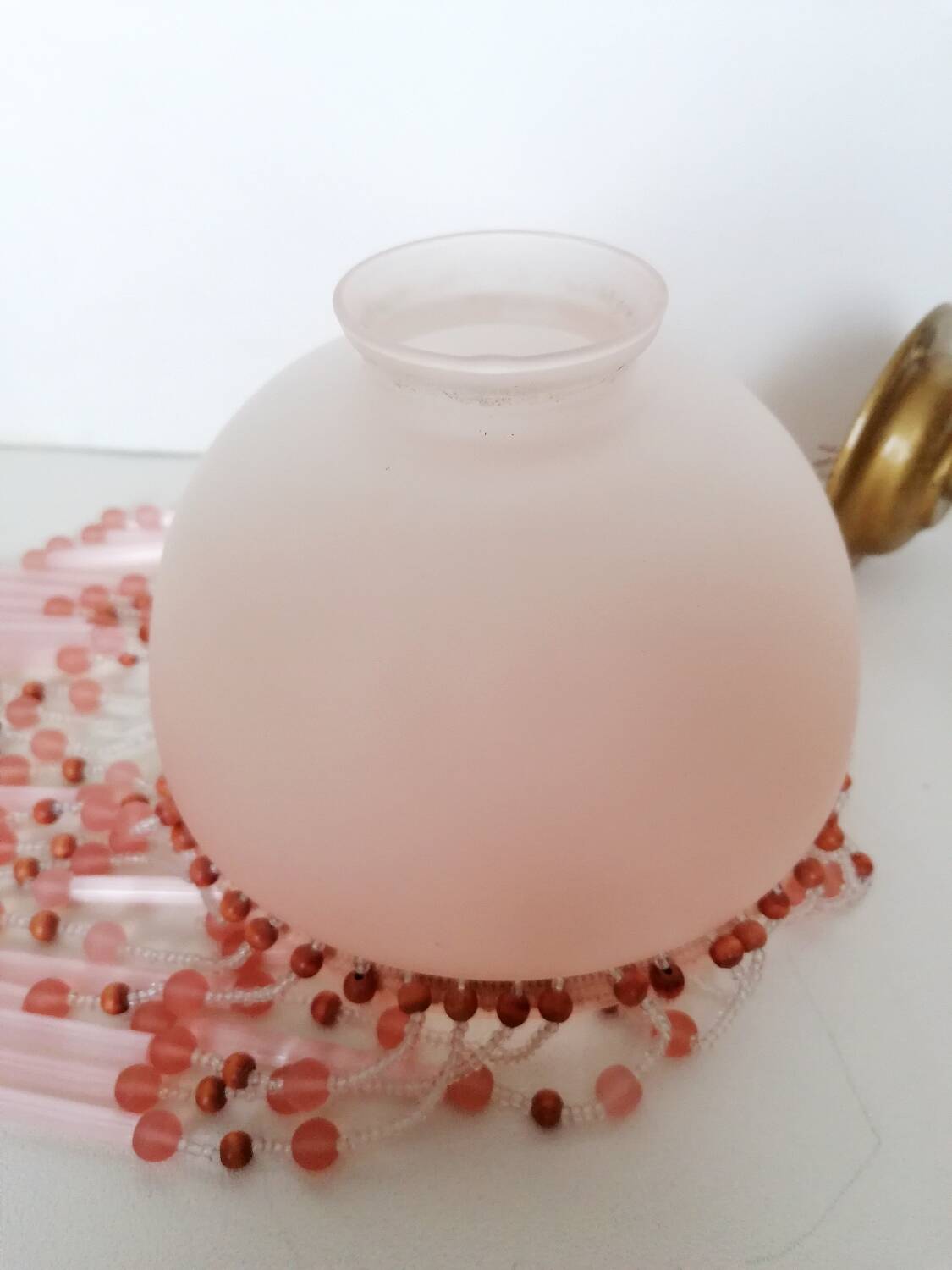 Pink glass wall lamp with garland of pearls