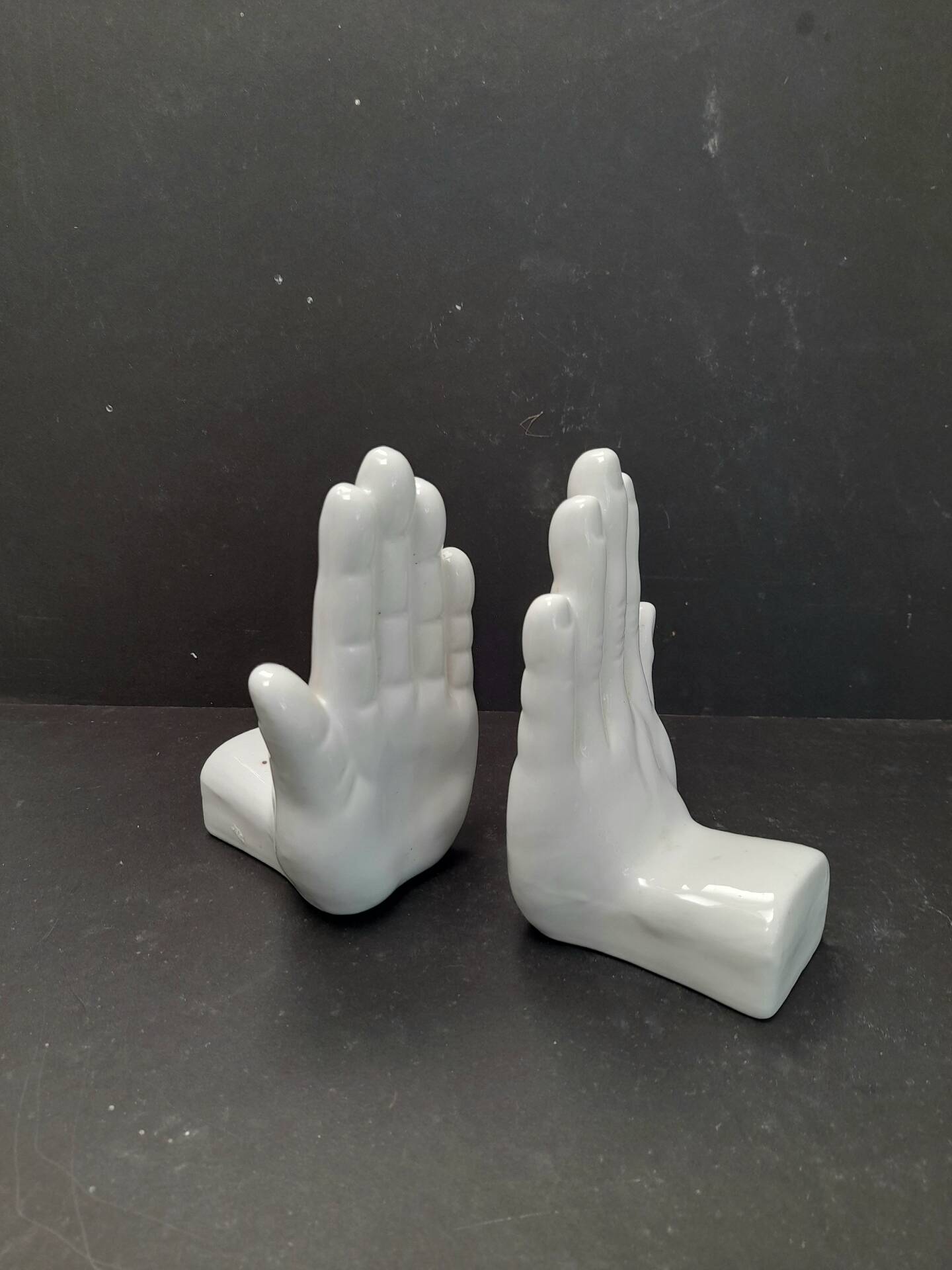 Ceramic bookends in the shape of hands.