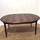 Extendable dining table in Rio rosewood.