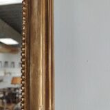 Long wooden mirror and gilded stucco with pearl rays H: 2m45 L: 40cm
