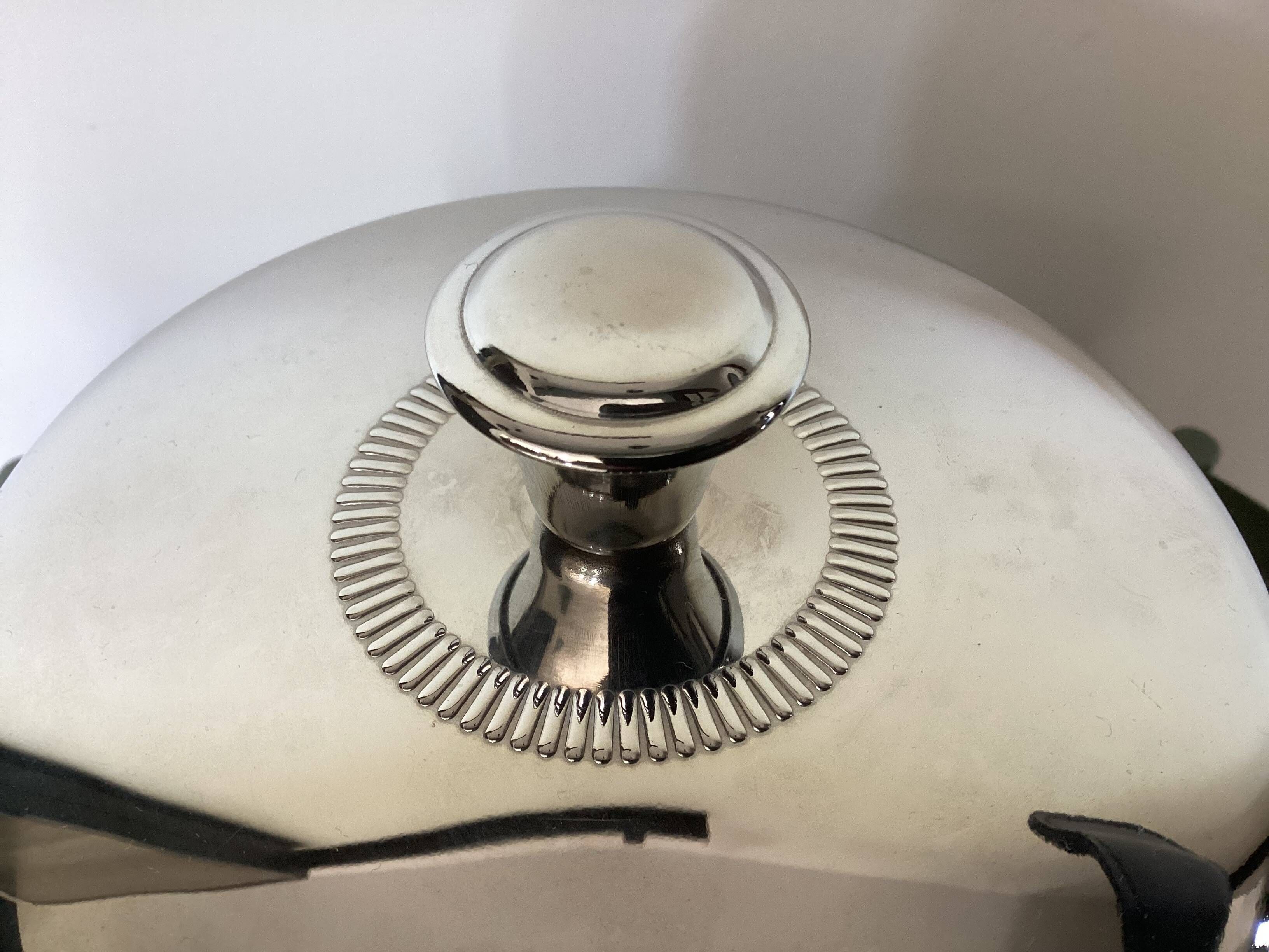 Vintage silver-plated ice bucket with lid and handles.