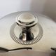 Vintage silver-plated ice bucket with lid and handles.