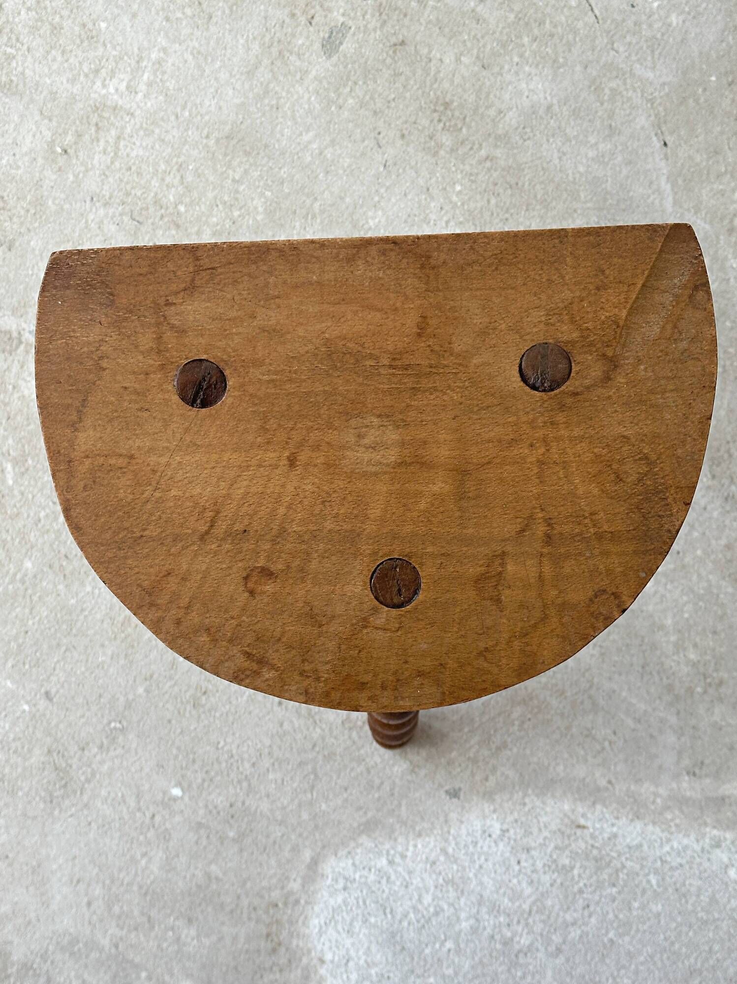 Antique solid wood stool with turned legs.