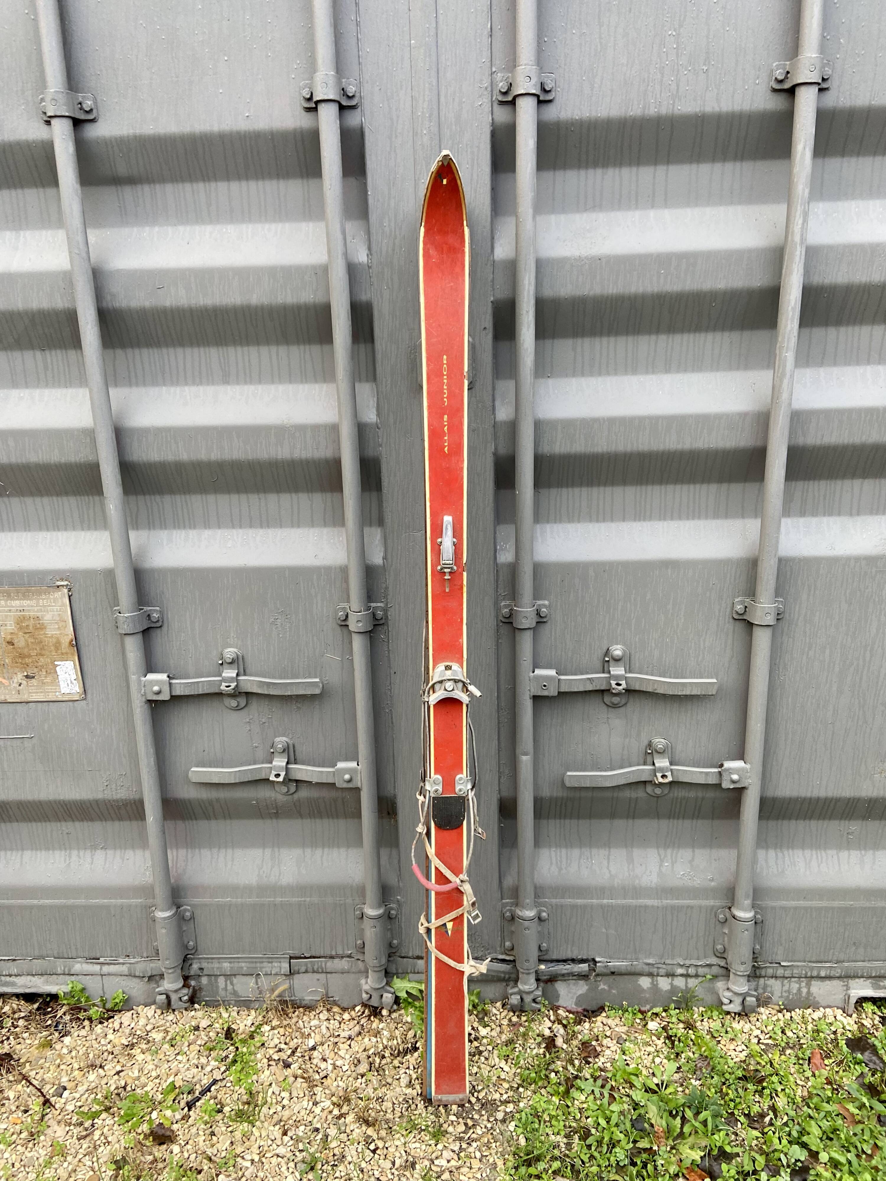 Pair of red antique skis