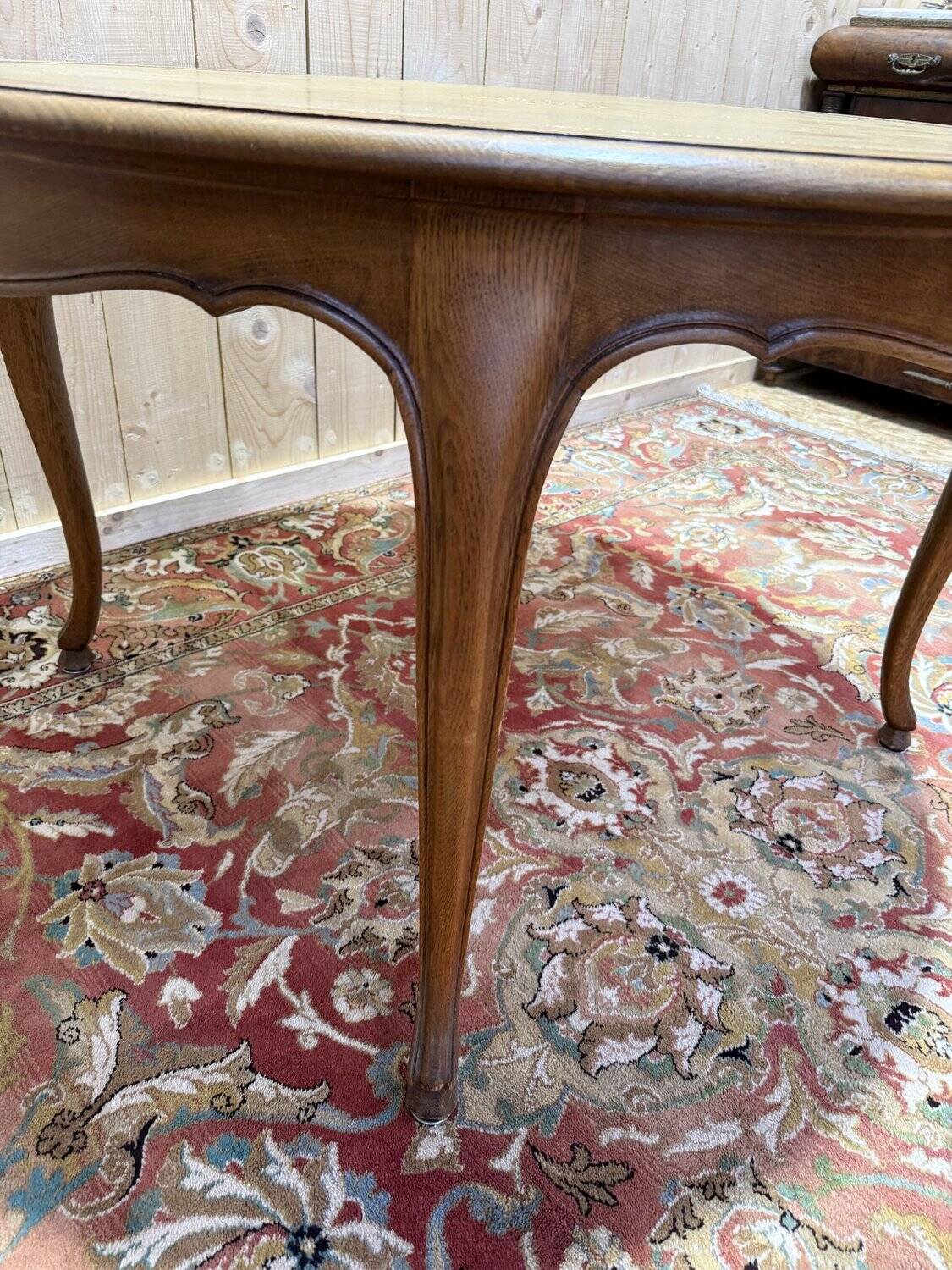 Round oak dining table with leather in Louis XV style.