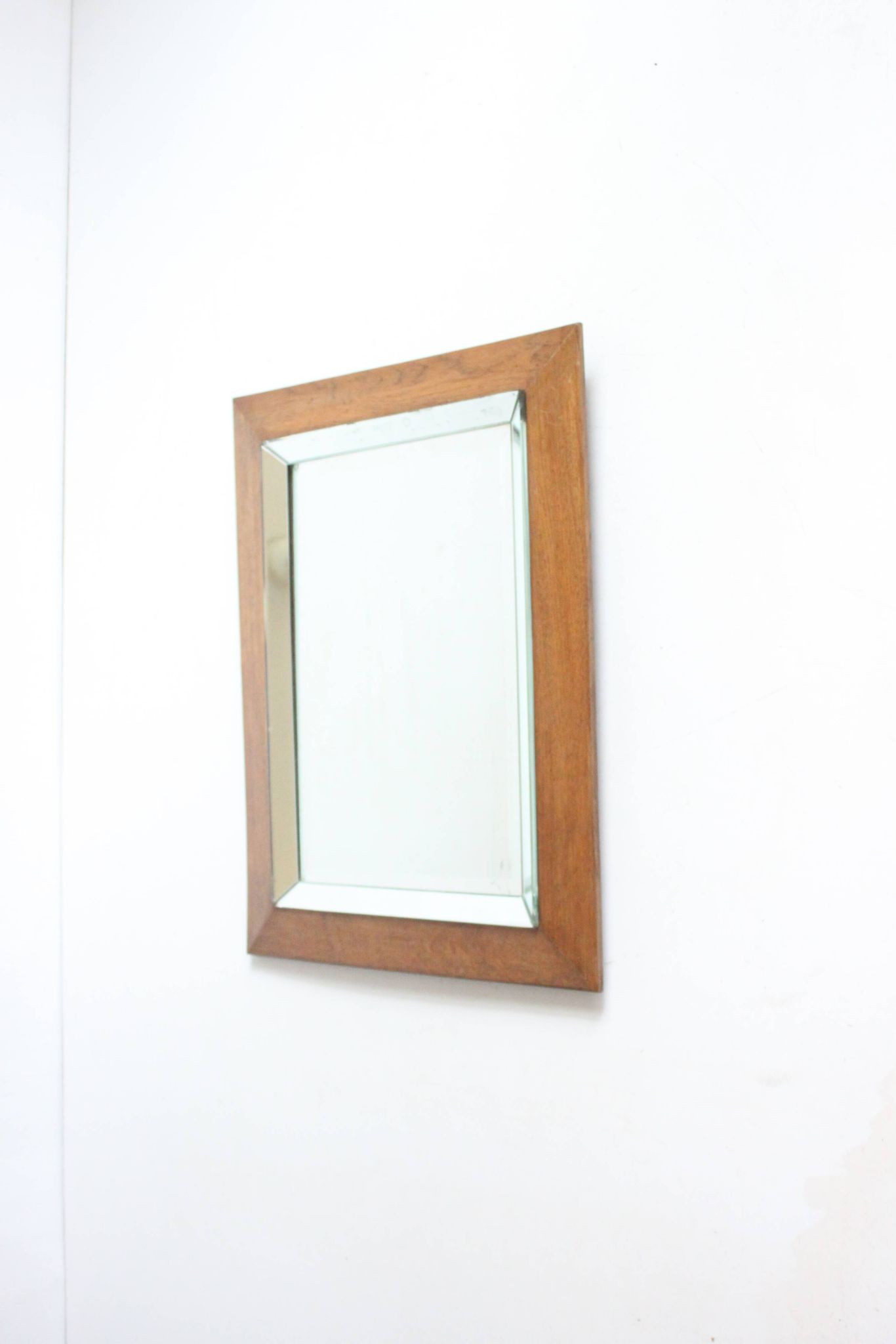 Art deco beveled mirror in an oak frame, 1940s.