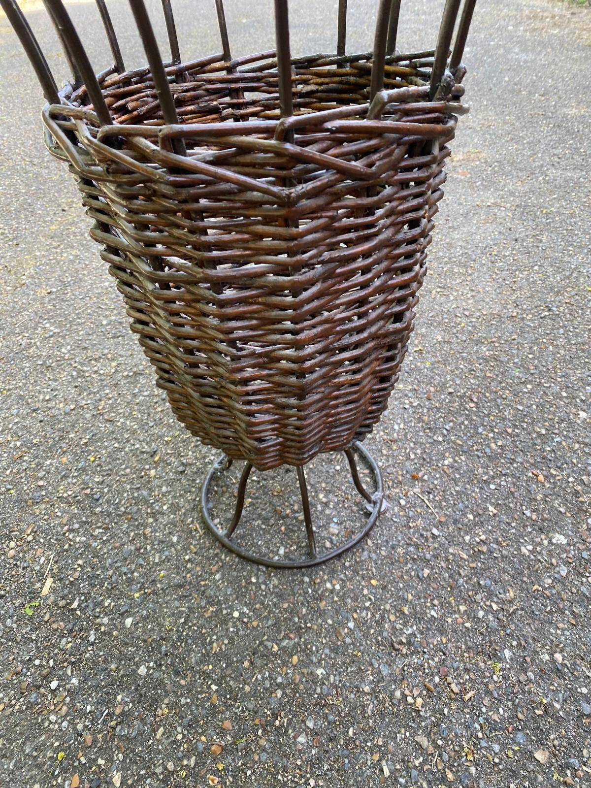 Vintage umbrella stand in rattan, woven wicker, and steel.