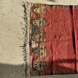 Small wool rug, predominantly red with geometric patterns
