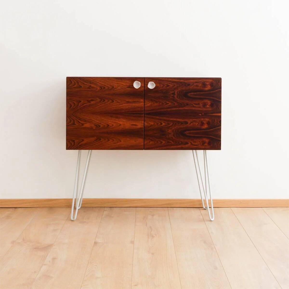 Buffet en palissandre avec des pieds en métal gris clair en forme de épingle.