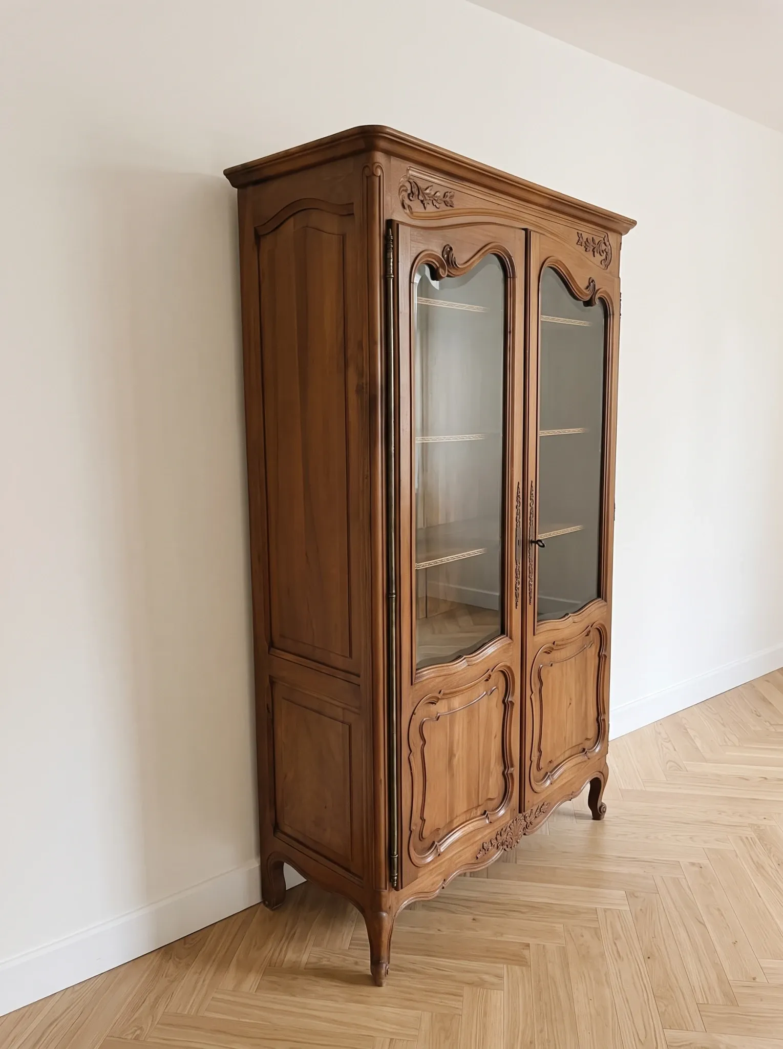 Antique display cabinet in Louis XV style made of wood.